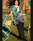 Carissa Vest Description - Vest 100% RECLÉM cotton thigh-length, sleeveless, large shawl collar wrap Color - Multi color Size - one size fits all front view