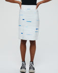 Clara 1 Skirt Description - 100% RECLÉM cotton peg skirt, knee length, back zipper, faced waist, bottom slit Color - white with blue (available in other color combinations) front view