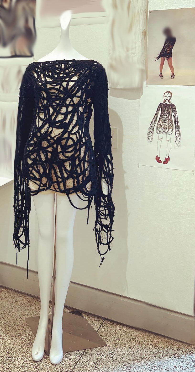 Long sleeve black top made of strings on mannequin