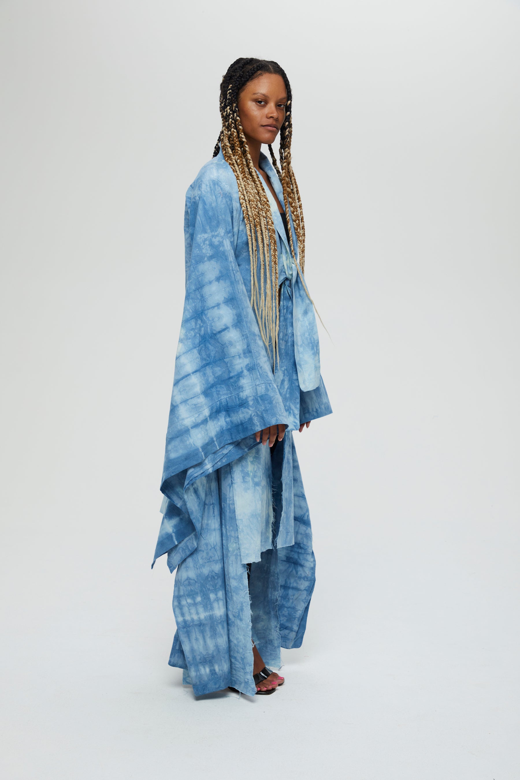 Akira Jacket Description - 100% cotton, knee length, flared sleeves front tie  Color - Indigo arashi shibori dyed  side view