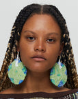 Green and blue earrings on model