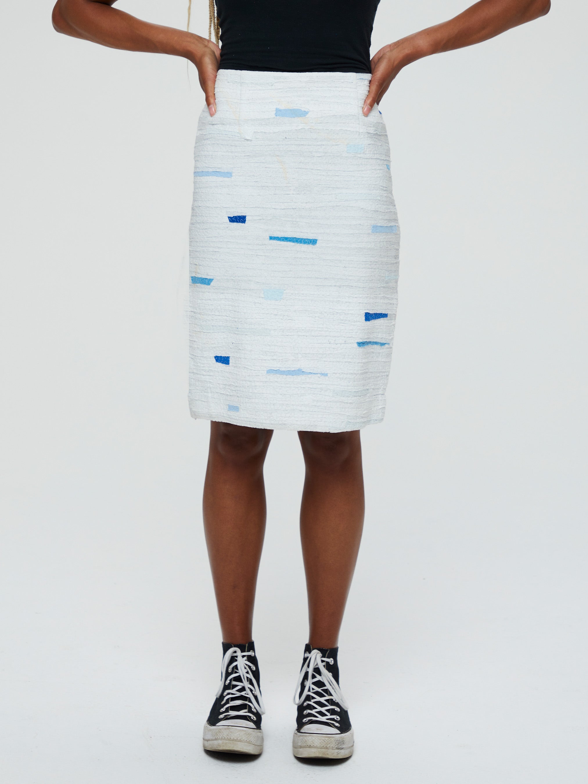 Clara 1 Skirt Description - 100% RECLÉM cotton peg skirt, knee length, back zipper, faced waist, bottom slit  Color - white with blue (available in other color combinations) front view