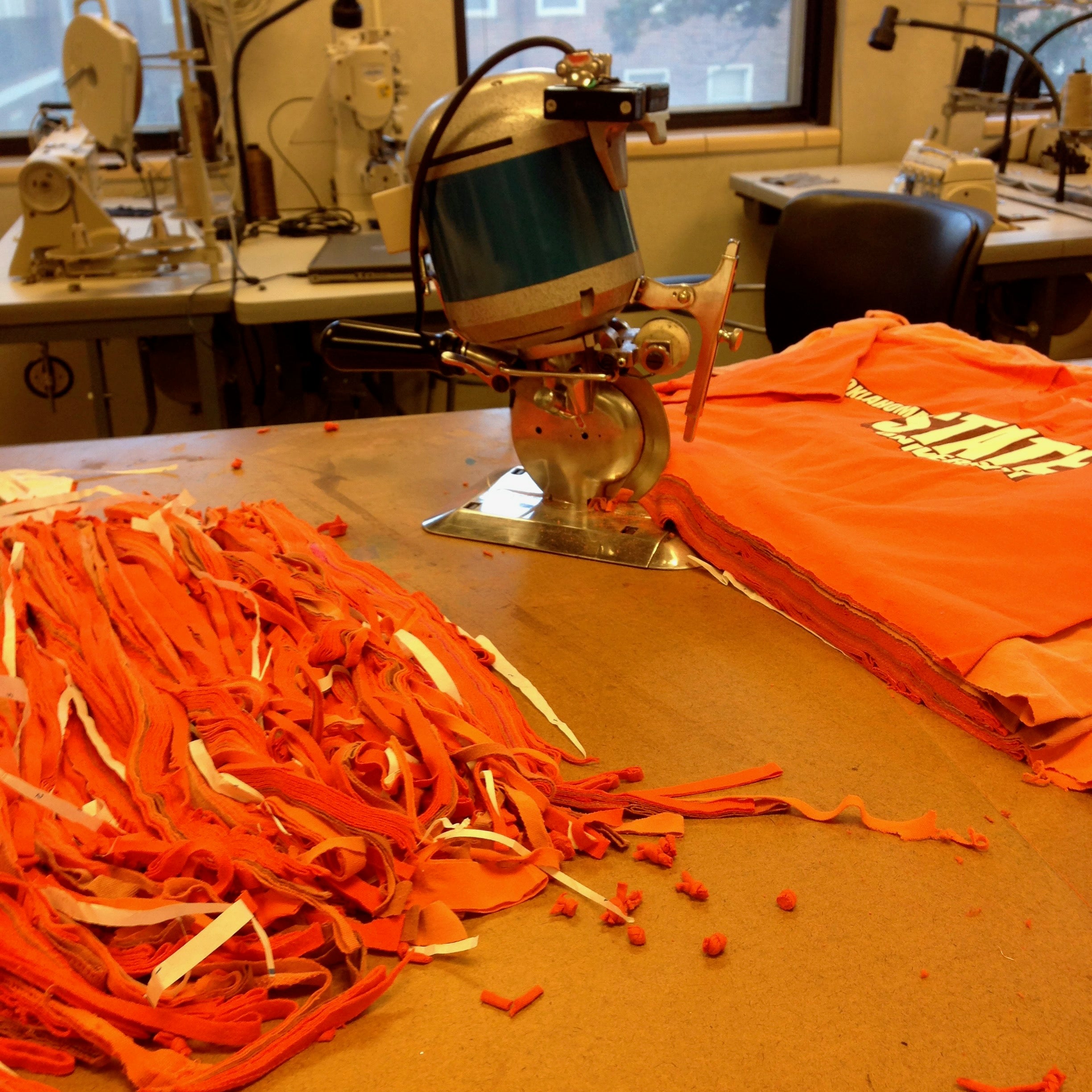 Orange strings used for reclem method being cut by machine