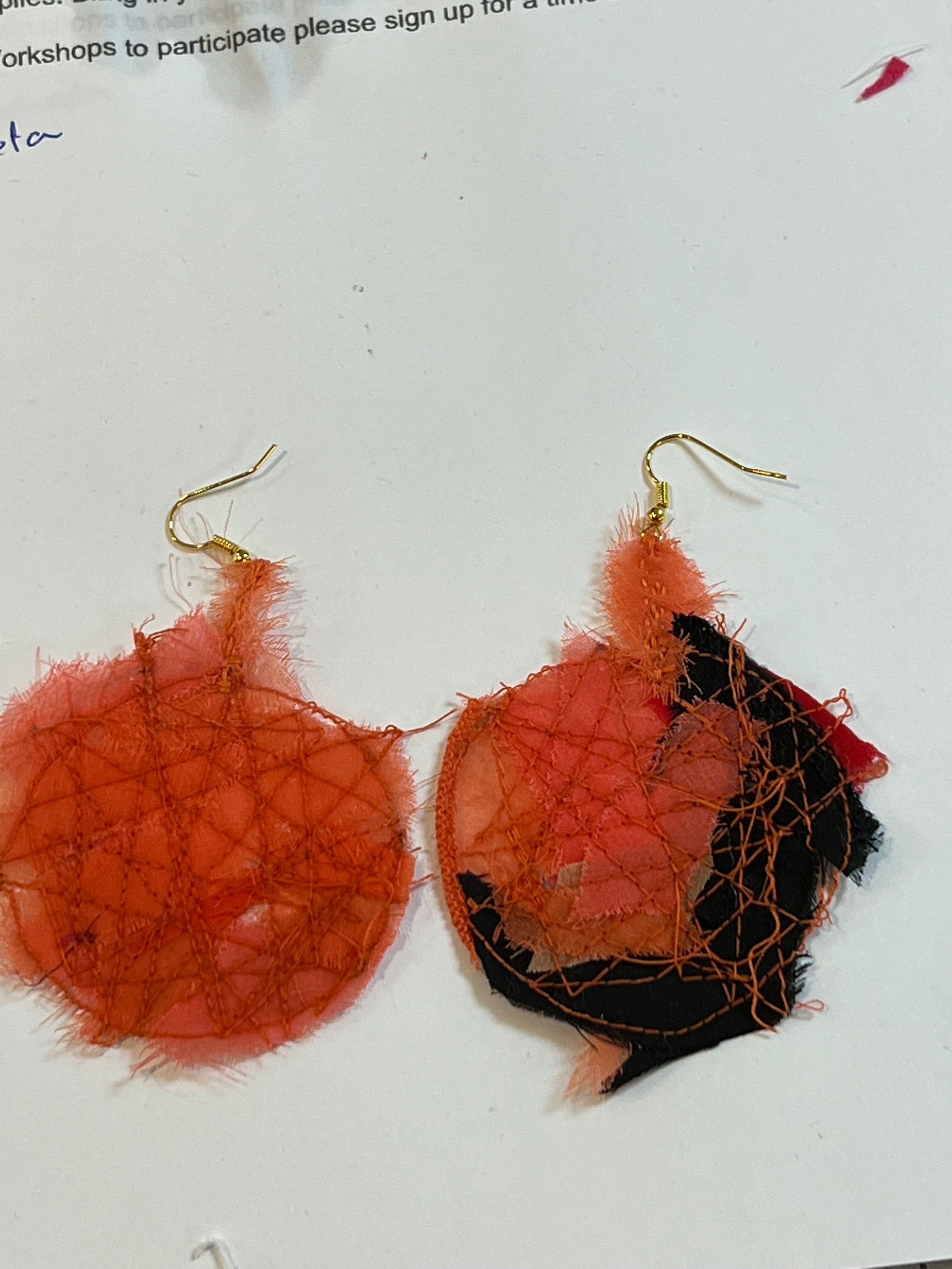 red and black earrings made using reclem method