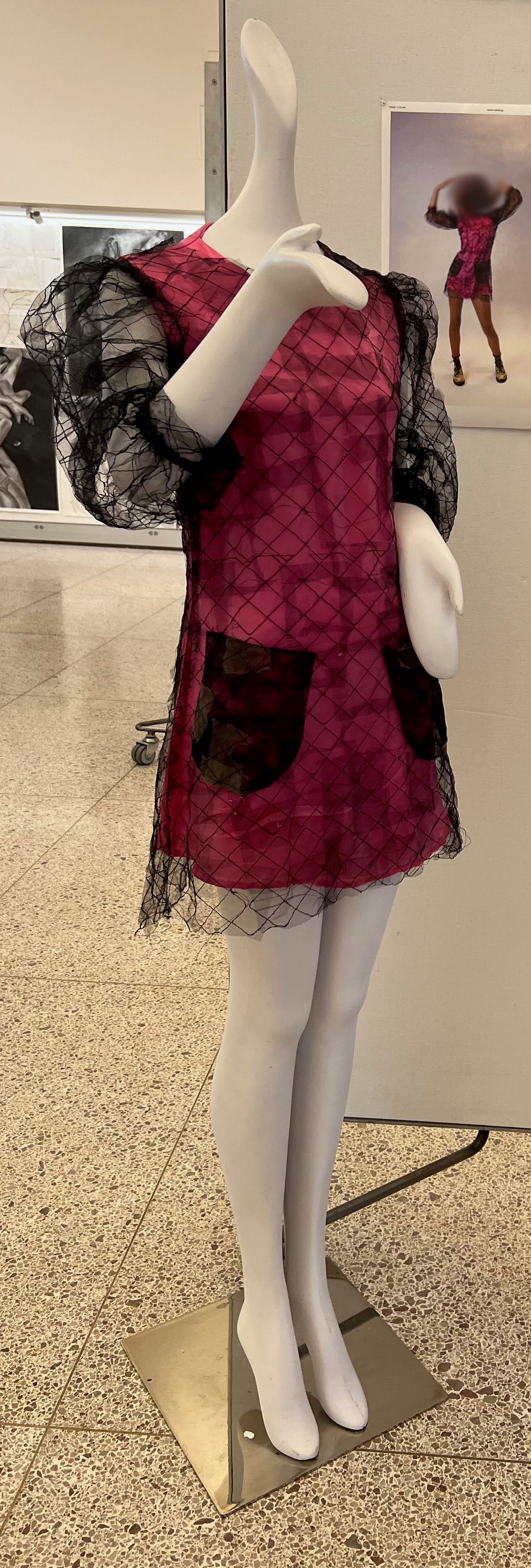 Red and black lace dress on mannequin