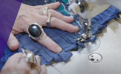 Close up of person sewing a garment