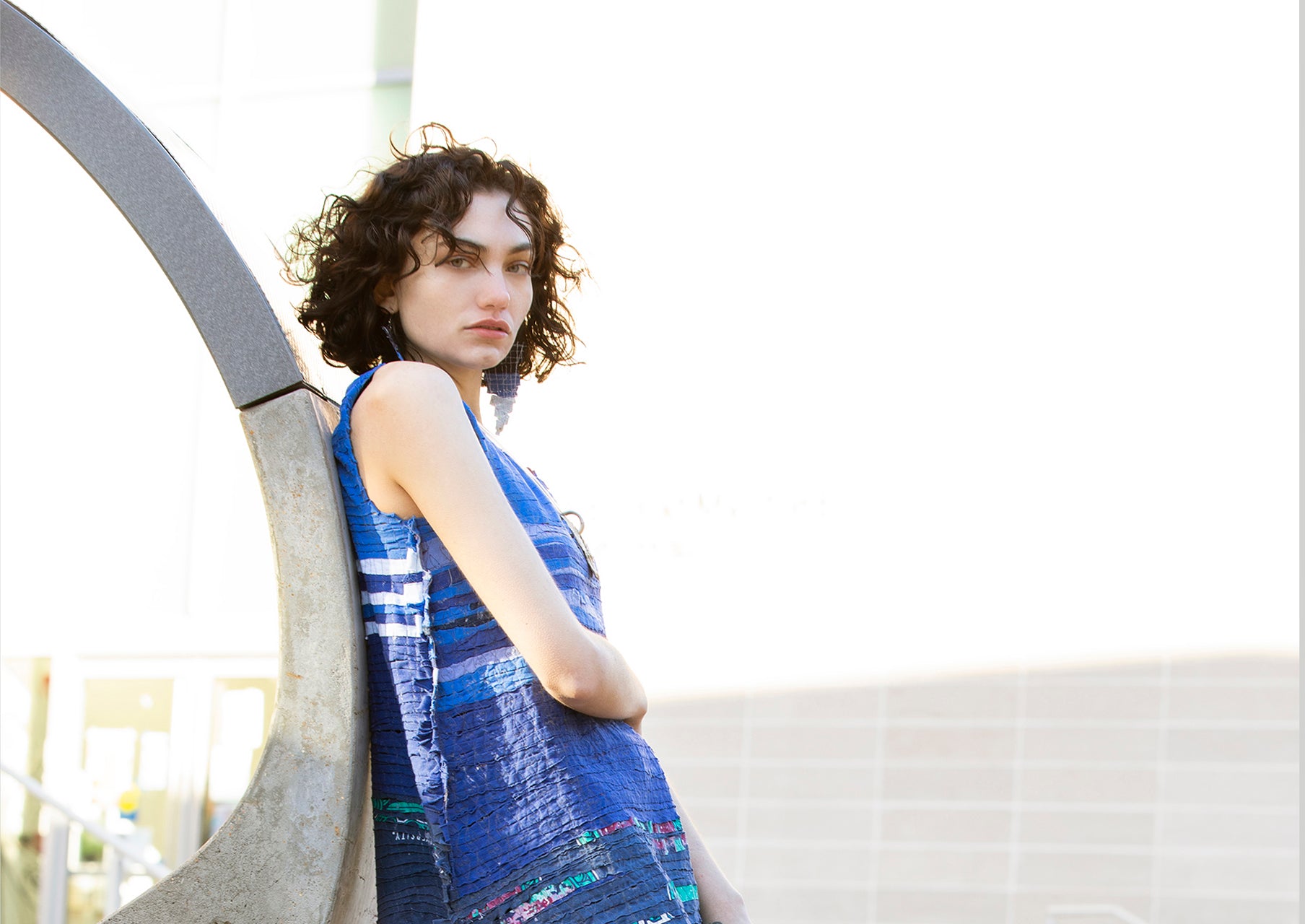 Blue sleeveless dress on model outside lifestyle shoot